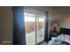 Bedroom sliding doors to a patio and fenced yard with an outdoor dining set at 864 Chianti Way, Mesquite, NV 89027