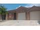 Well-lit exterior of a single-story home with a three-car garage and desert landscaping at 864 Chianti Way, Mesquite, NV 89027