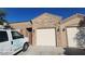 Charming single-story home showcasing a private garage entrance with stone accents and adjacent front door at 864 Chianti Way, Mesquite, NV 89027