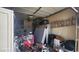 A cluttered garage with storage, a motorcycle, and an automatic door. Ready for organization and your vehicles at 864 Chianti Way, Mesquite, NV 89027