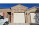 Charming single-story home showcasing a private garage entrance with stone accents and adjacent front door at 864 Chianti Way, Mesquite, NV 89027