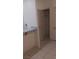 Hallway view with tile flooring, counter with granite top and closet at 864 Chianti Way, Mesquite, NV 89027
