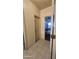 Hallway features neutral colors, tiled flooring, and doors to other rooms at 864 Chianti Way, Mesquite, NV 89027