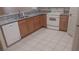 Well-lit kitchen features granite countertops, stainless steel sink, and white appliances at 864 Chianti Way, Mesquite, NV 89027