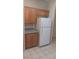 The well-lit kitchen boasts wooden cabinets, granite countertops, and white appliances at 864 Chianti Way, Mesquite, NV 89027