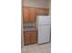 The well-lit kitchen boasts wooden cabinets, granite countertops, and white appliances at 864 Chianti Way, Mesquite, NV 89027