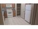 Functional kitchen with white appliances, light wood cabinetry, granite countertops, and tile flooring at 864 Chianti Way, Mesquite, NV 89027