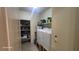 Functional laundry area featuring a washer, dryer, and ample shelving space at 864 Chianti Way, Mesquite, NV 89027