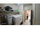 A well-equipped laundry room with a washer, dryer, and storage solutions at 864 Chianti Way, Mesquite, NV 89027