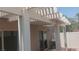 Covered patio area with white pergola, sliding doors and an AC unit, perfect for entertaining at 864 Chianti Way, Mesquite, NV 89027
