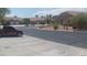Charming single-story homes line a well-maintained street with desert landscaping and a red truck in the foreground at 864 Chianti Way, Mesquite, NV 89027