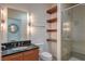 Stylish bathroom with a modern vanity, wood shelving, and a glass-enclosed shower, designed for comfort and luxury at 900 S Las Vegas Blvd # 1208, Las Vegas, NV 89101