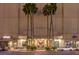 Elegant building entrance featuring tall palm trees, decorative landscaping, and a sleek, modern glass facade at 900 S Las Vegas Blvd # 1208, Las Vegas, NV 89101