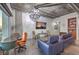 Bright living room with chandelier, sleek concrete ceiling, and a full wall of windows with city views at 900 S Las Vegas Blvd # 1208, Las Vegas, NV 89101