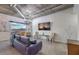 Stylish living room with city views, industrial ductwork, chandelier lighting, and comfortable seating at 900 S Las Vegas Blvd # 1208, Las Vegas, NV 89101