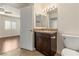 Well-lit bathroom with granite countertop, double vanity, tile floors, and toilet at 950 Seven Hills Dr # 2924, Henderson, NV 89052