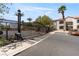 Gated community entrance with black iron gate, palm trees, and visitor parking at 950 Seven Hills Dr # 2924, Henderson, NV 89052
