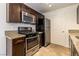 Well-equipped kitchen with granite countertops, stainless steel appliances, and dark cabinetry at 950 Seven Hills Dr # 2924, Henderson, NV 89052