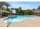 Beautiful community pool with spa, lounge seating, and palm trees creating a relaxing oasis at 950 Seven Hills Dr # 2924, Henderson, NV 89052