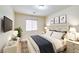 Well-lit bedroom featuring a queen bed, matching nightstands, and tasteful wall decor at 10311 Birch Bluff Lane Ln, Las Vegas, NV 89145