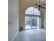Open concept living space with high ceilings, tile floors, and sliding glass doors, bathed in natural light at 10311 Birch Bluff Lane Ln, Las Vegas, NV 89145