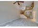 Open-concept living room with high ceilings, staircase, and tile flooring showcases a spacious interior at 10311 Birch Bluff Lane Ln, Las Vegas, NV 89145
