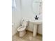 Clean half-bathroom with pedestal sink, modern fixtures and neutral finishes at 10376 Joaquin Fire St, Las Vegas, NV 89141