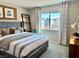 Stylish bedroom with a bed dressed in cozy linens and window with neighborhood views at 10376 Joaquin Fire St, Las Vegas, NV 89141