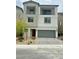 Two-story home featuring dual balconies and a well-manicured, low-maintenance front yard at 10376 Joaquin Fire St, Las Vegas, NV 89141