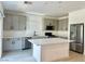 Modern kitchen featuring quartz countertops, stainless steel appliances, and light gray cabinetry at 10376 Joaquin Fire St, Las Vegas, NV 89141