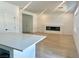 Bright living room and kitchen featuring sleek quartz counters and neutral finishes at 10376 Joaquin Fire St, Las Vegas, NV 89141