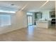 Bright, open-concept living space with hardwood floors and a modern kitchen in background at 10376 Joaquin Fire St, Las Vegas, NV 89141