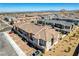 Scenic aerial shot of well-planned townhomes with paver driveways and desert landscaping, blending community living at 10773 Bede Ct, Las Vegas, NV 89166
