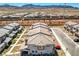 Stunning aerial view of a modern townhome community with desert landscaping and mountain views in the background at 10773 Bede Ct, Las Vegas, NV 89166