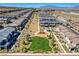 Community aerial view featuring new townhomes, a park with green space, and a playground with ample desert landscaping at 10773 Bede Ct, Las Vegas, NV 89166