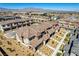 Overview of new townhomes in a desert community, featuring desert landscaping, modern design, and mountain views at 10773 Bede Ct, Las Vegas, NV 89166