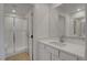 Bright bathroom featuring a modern vanity with white countertop and a glass-enclosed shower at 10773 Bede Ct, Las Vegas, NV 89166