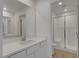 Bright bathroom featuring a modern vanity with white countertop and a glass-enclosed shower at 10773 Bede Ct, Las Vegas, NV 89166