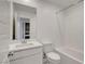 Well-lit bathroom featuring a modern vanity, toilet, and tub with white subway tile at 10773 Bede Ct, Las Vegas, NV 89166