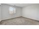 Bright, carpeted bedroom with a large window providing ample natural light at 10773 Bede Ct, Las Vegas, NV 89166