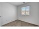 Cozy bedroom featuring a window with blinds, carpeted floors, and neutral wall color at 10773 Bede Ct, Las Vegas, NV 89166