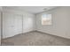 Cozy bedroom featuring carpet, closet with white doors, and natural light at 10773 Bede Ct, Las Vegas, NV 89166