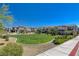Community park and playground area featuring lush lawn, walking path, and picnic area at 10773 Bede Ct, Las Vegas, NV 89166