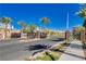 Gated entrance to the community featuring decorative metal gates, mature palm trees and professional landscaping at 10773 Bede Ct, Las Vegas, NV 89166