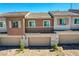 Close up on three townhome garages, showing individual details and landscaping. Paver stones highlight the driveways at 10773 Bede Ct, Las Vegas, NV 89166
