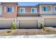 A row of homes with individual garages and a beautifully landscaped entrance at 10773 Bede Ct, Las Vegas, NV 89166