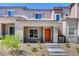 Inviting two-story home features an orange front door, low maintenance landscaping, and a concrete walkway at 10773 Bede Ct, Las Vegas, NV 89166