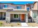 Home's front entrance featuring a charming brick entrance, complemented by a colorful orange door at 10773 Bede Ct, Las Vegas, NV 89166