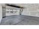 A view of a spacious two car garage leading to an outdoor view of neighboring homes at 10773 Bede Ct, Las Vegas, NV 89166