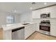 New kitchen with stainless steel appliances, an island and large countertops at 10773 Bede Ct, Las Vegas, NV 89166